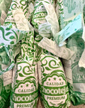 Coconut chocotejas in green paper wrappers.