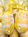 Walnut chocotejas in yellow paper wrappers.